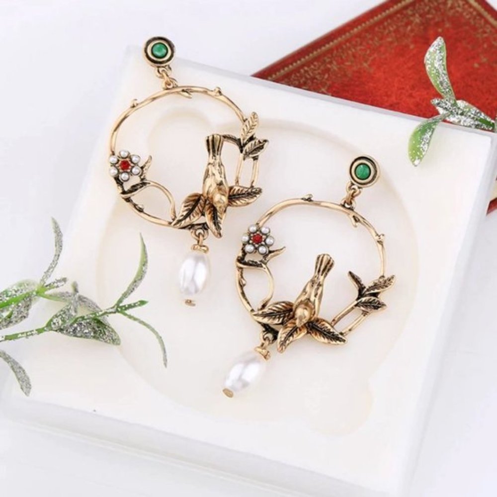 Anthropologie gold-toned hoops w/ faux-pearl embellishment & bird/vine motif
